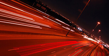Night view of a highway with cars driving
