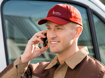 Baker Electric service rep on the phone with a client