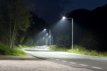 View of city road at night with row of street lights